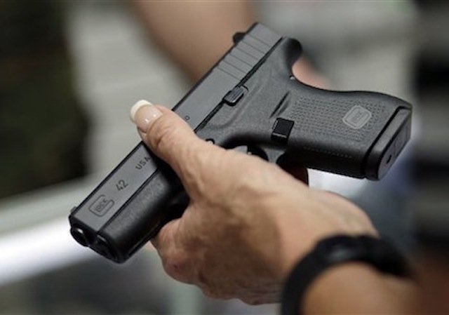 Woman holding gun